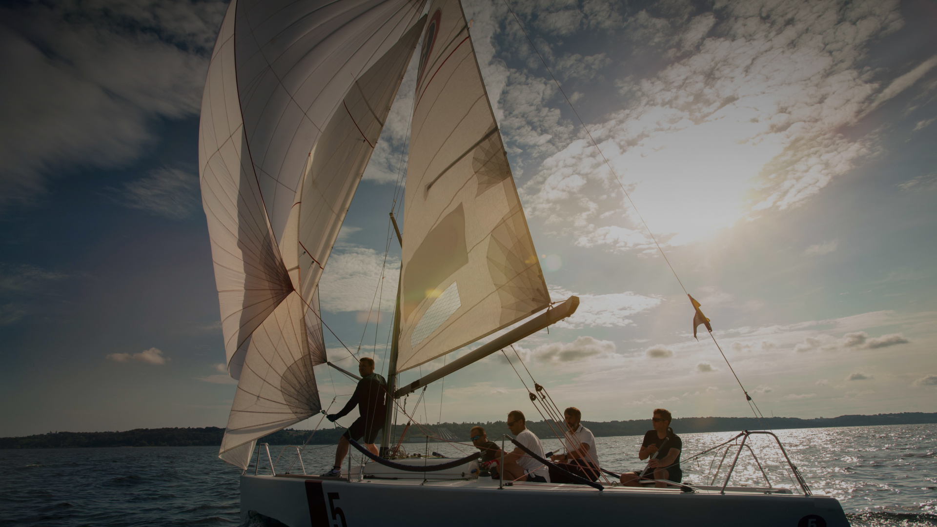 Sailing on open water at dusk — Pelagus adventure-led recovery retreats