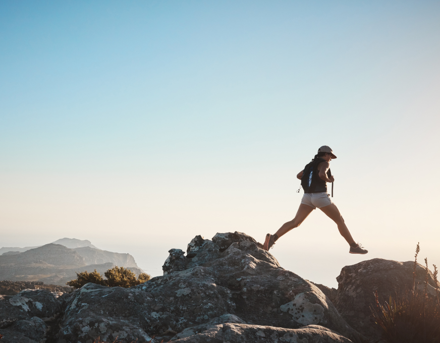Leaping between rocks on a coastal hike