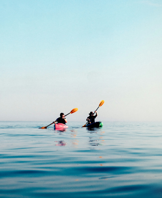 Two people kayaking on calm water