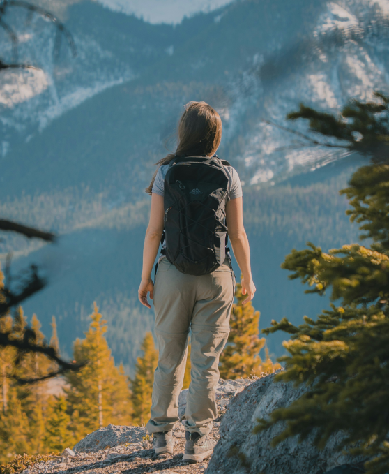 A hiker looking out over autumn mountains