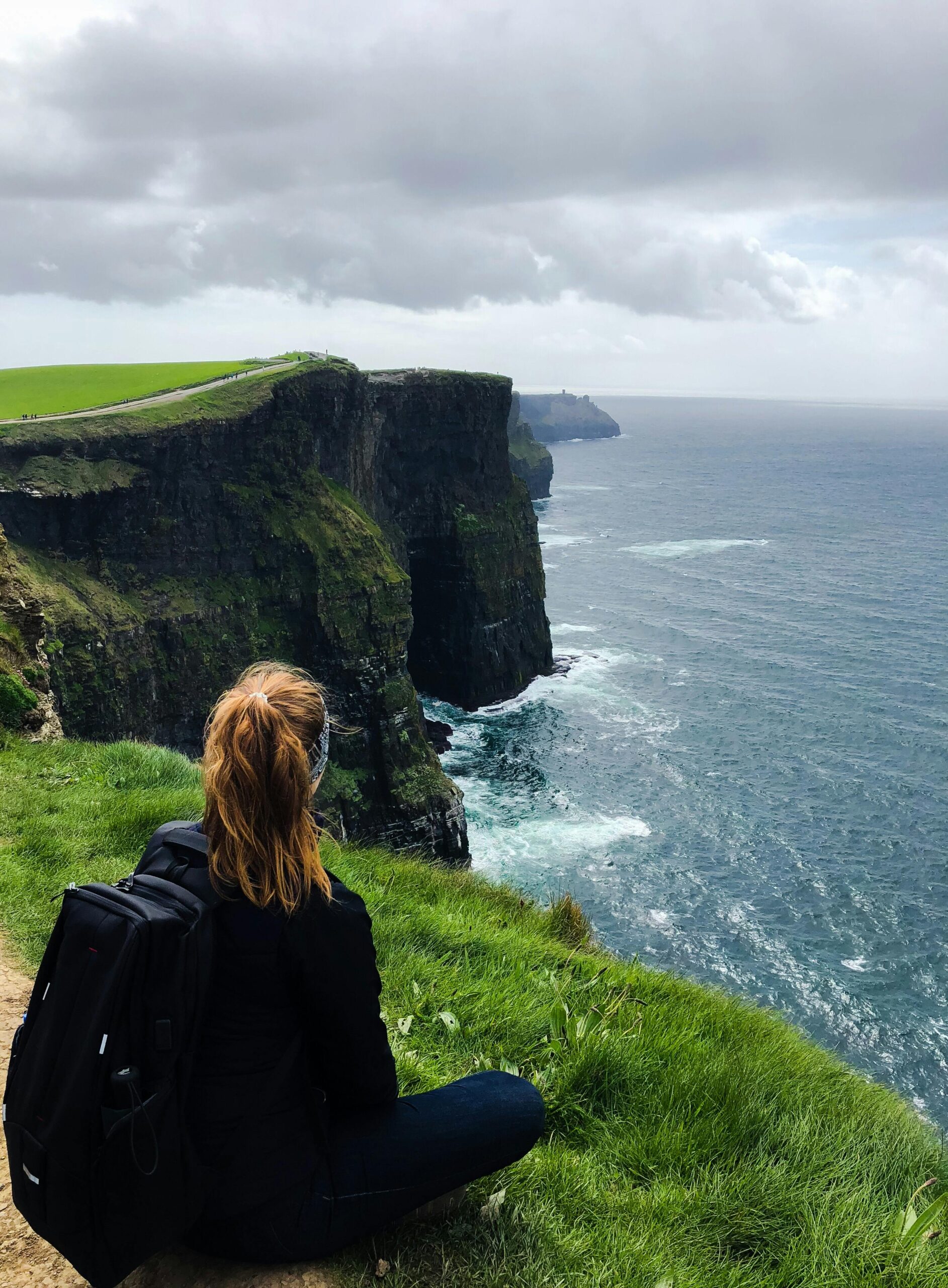 Sitting at the edge of the Cliffs of Moher